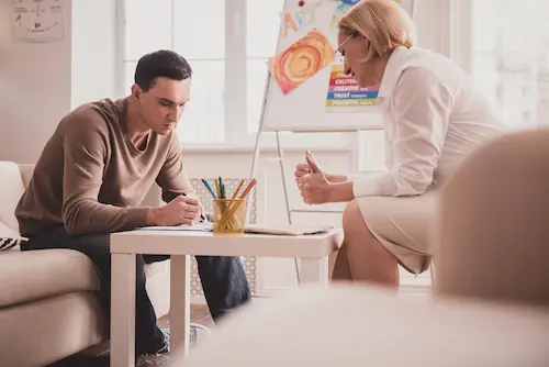 Therapist observing a client during an art therapy session