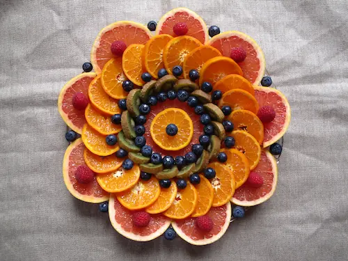 Close-up of intricate mandala art coloring page with colored pencils